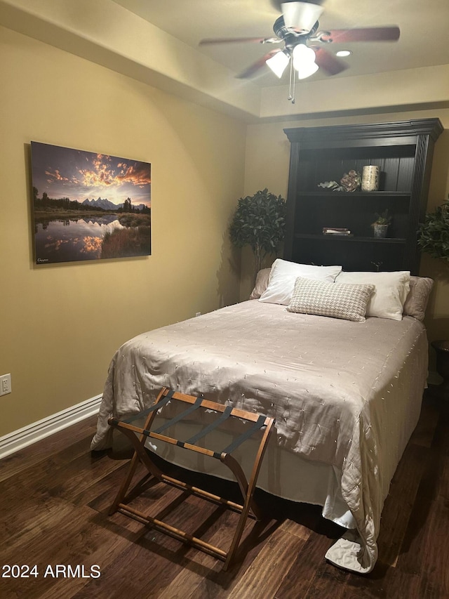 bedroom featuring ceiling fan and dark wood-type flooring