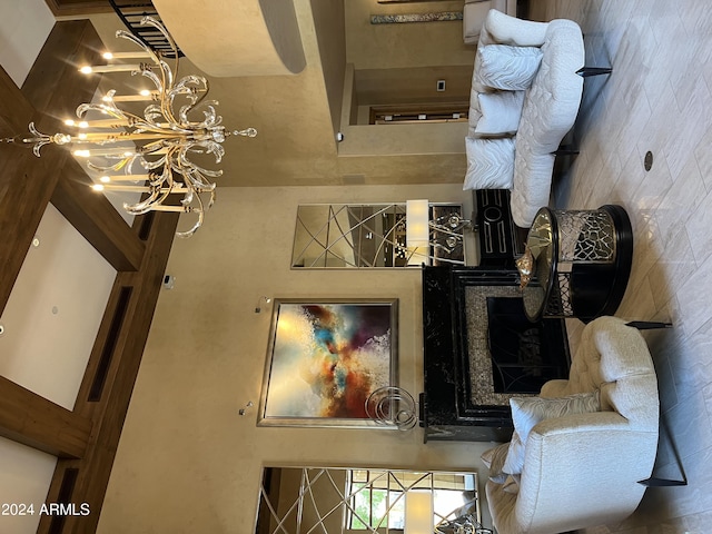 living room featuring a towering ceiling and a chandelier