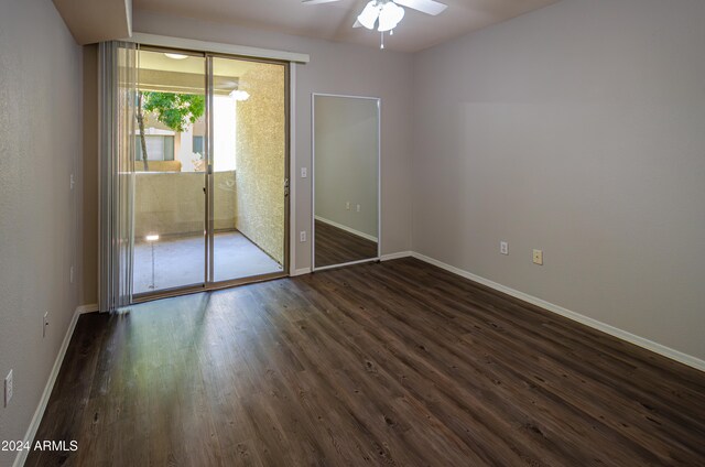 unfurnished bedroom with dark wood-type flooring, ceiling fan, and a closet