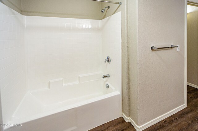 bathroom with wood-type flooring and shower / washtub combination