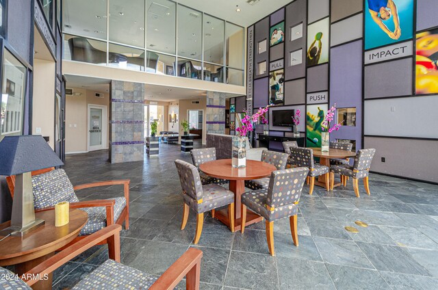 dining space with a towering ceiling