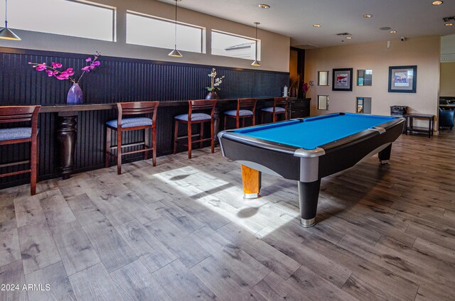 rec room featuring hardwood / wood-style flooring, bar area, and billiards