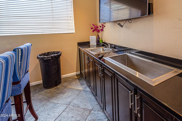 kitchen with sink and dark brown cabinetry