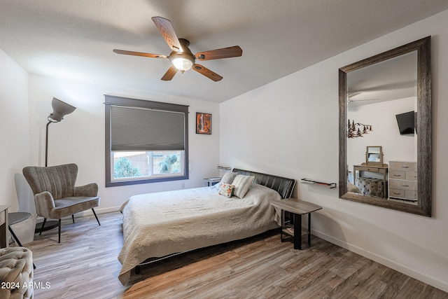 bedroom with ceiling fan and wood-type flooring