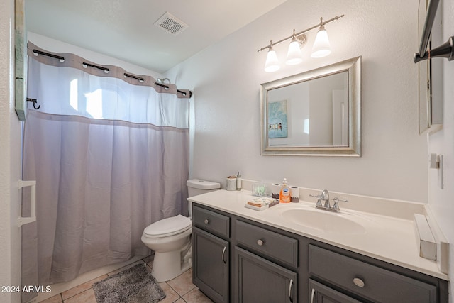 bathroom featuring toilet, vanity, tile patterned floors, and walk in shower