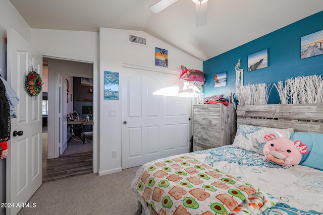 bedroom with ceiling fan, a closet, light colored carpet, and lofted ceiling