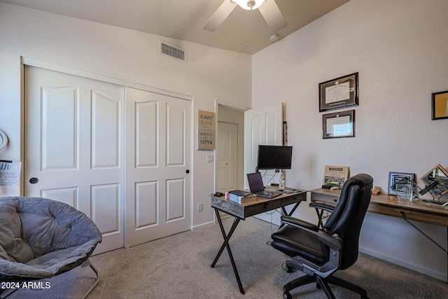 carpeted office featuring ceiling fan