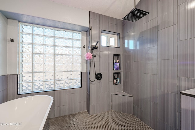 bathroom with tile walls, plus walk in shower, and a textured ceiling