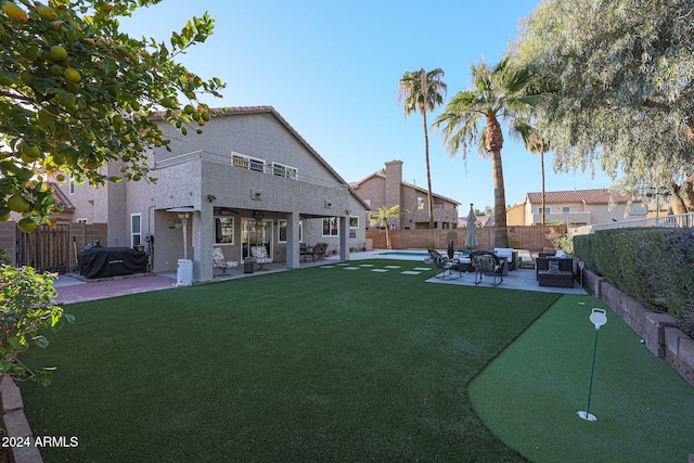 view of yard featuring a patio area, an outdoor hangout area, and a fenced in pool