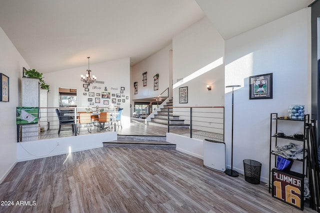 interior space featuring hardwood / wood-style flooring, vaulted ceiling, and a chandelier