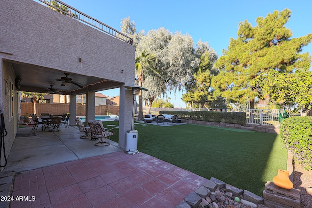 view of yard with a patio area and ceiling fan