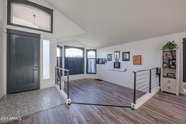 entrance foyer featuring wood-type flooring and high vaulted ceiling