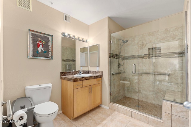 bathroom with vanity, an enclosed shower, tile patterned flooring, and toilet