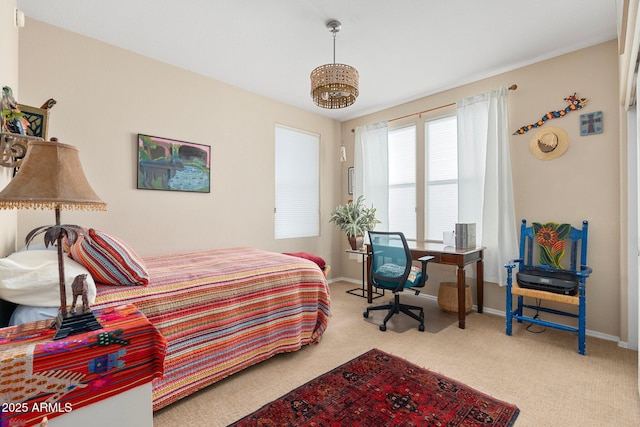 carpeted bedroom with a chandelier