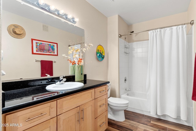 full bathroom featuring shower / bathtub combination with curtain, vanity, hardwood / wood-style flooring, and toilet