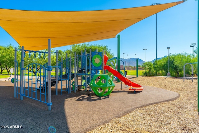 view of jungle gym with a mountain view