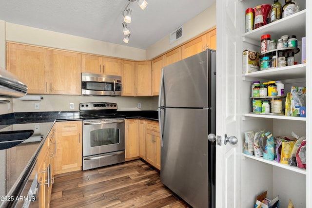 kitchen featuring dark wood-type flooring, sink, a textured ceiling, light brown cabinets, and appliances with stainless steel finishes