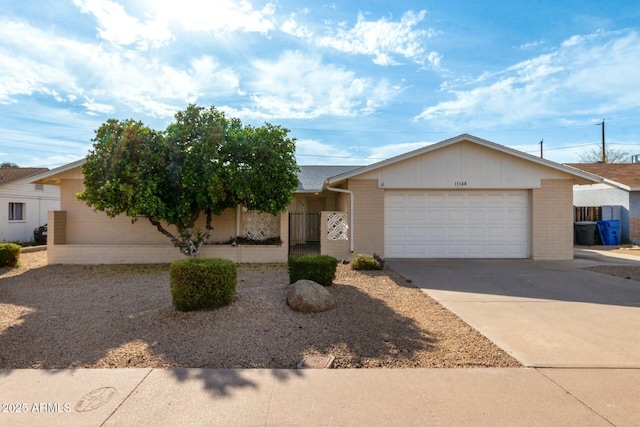 ranch-style house featuring an attached garage, brick siding, and concrete driveway