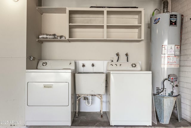 washroom featuring water heater, laundry area, brick wall, and washing machine and clothes dryer