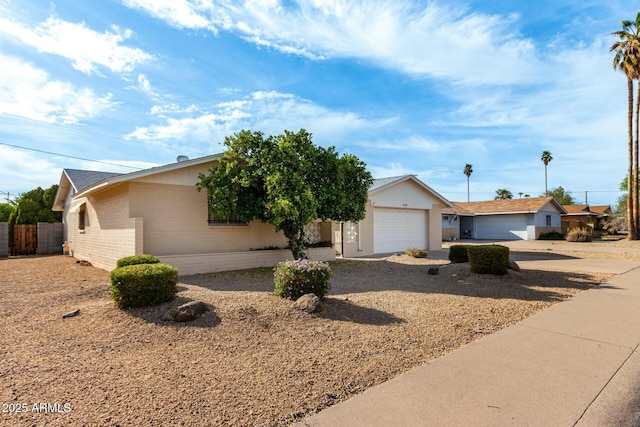 single story home featuring fence, a garage, brick siding, and concrete driveway
