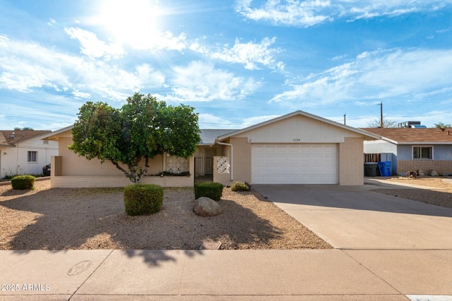 single story home with an attached garage, brick siding, and concrete driveway