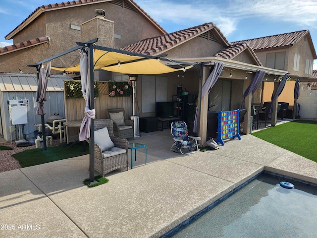 back of property with a patio, a tiled roof, fence, and stucco siding