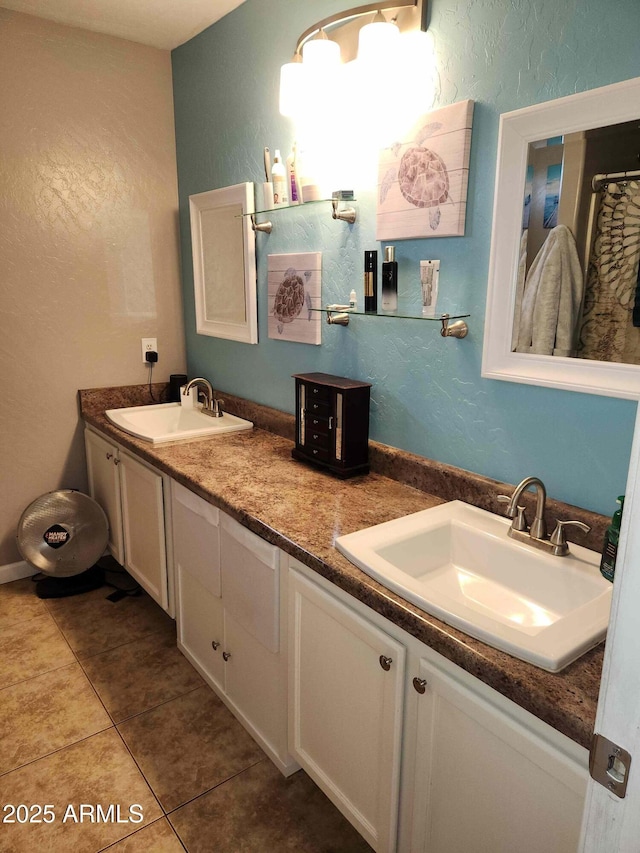 full bath with a textured wall, tile patterned floors, and double vanity