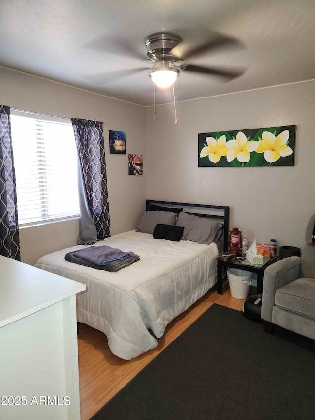 bedroom with wood finished floors and ceiling fan