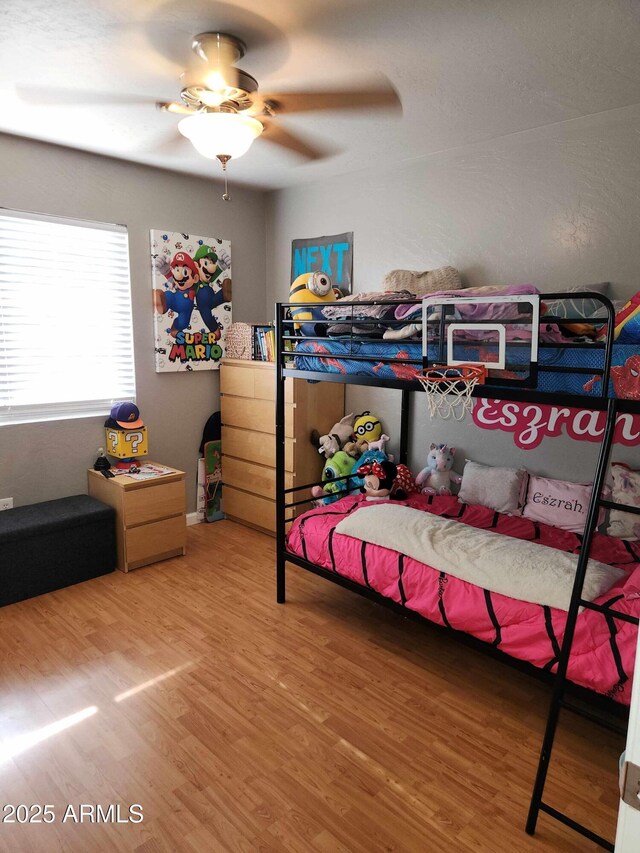 bedroom with wood finished floors and ceiling fan