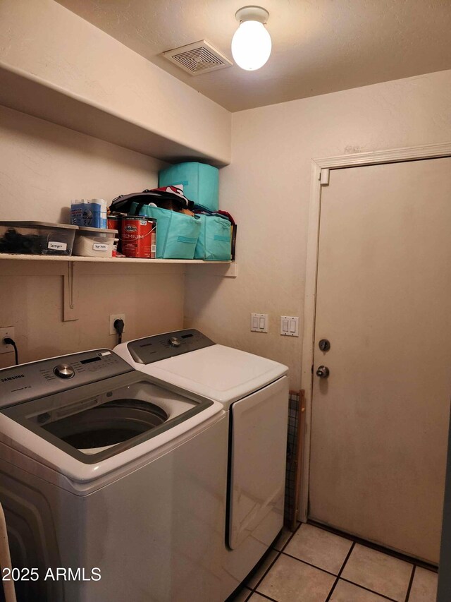 washroom featuring separate washer and dryer and light tile patterned floors
