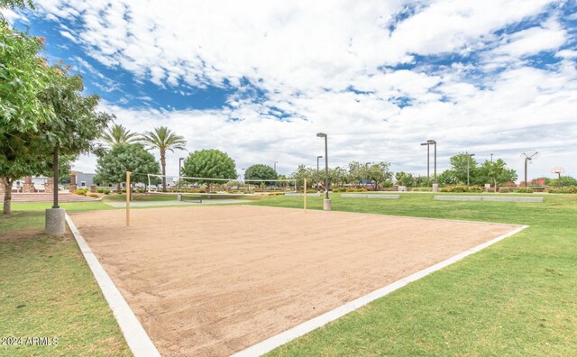 view of property's community featuring a yard and volleyball court