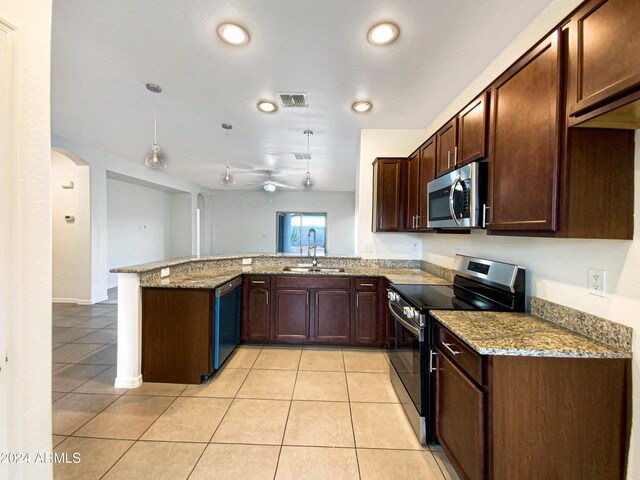 kitchen with light stone counters, visible vents, appliances with stainless steel finishes, a sink, and a peninsula