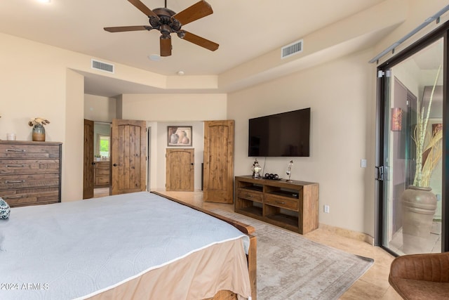 bedroom with ensuite bathroom and ceiling fan