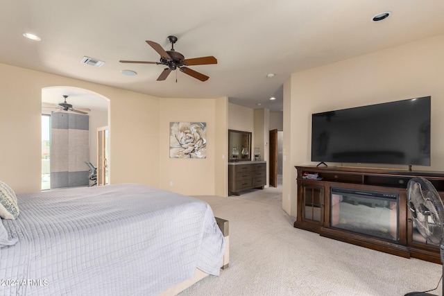 carpeted bedroom featuring ceiling fan and connected bathroom