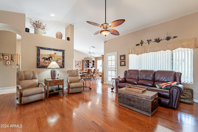 living room featuring hardwood / wood-style floors, high vaulted ceiling, and ceiling fan