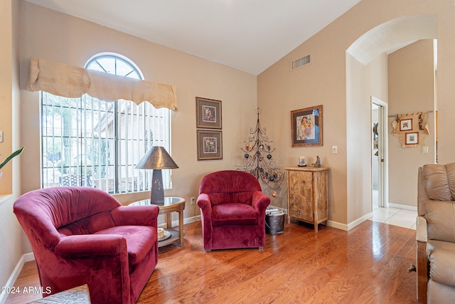 sitting room with hardwood / wood-style floors and lofted ceiling