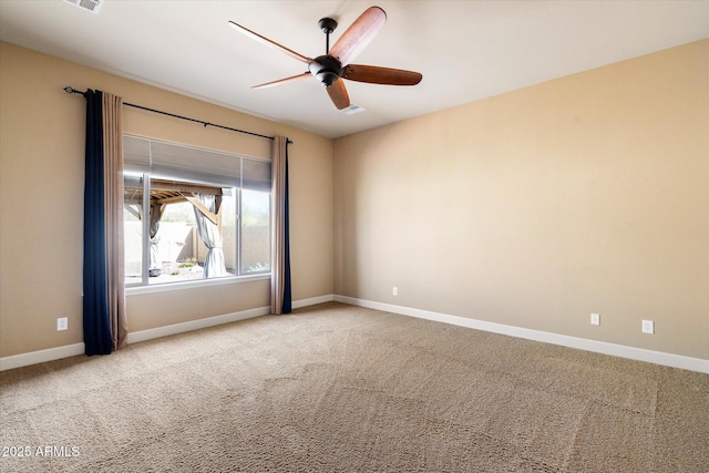 carpeted spare room with baseboards and ceiling fan