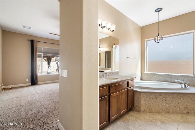 bathroom featuring a bath, visible vents, and vanity