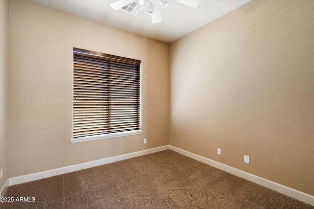 carpeted empty room featuring visible vents, baseboards, and ceiling fan