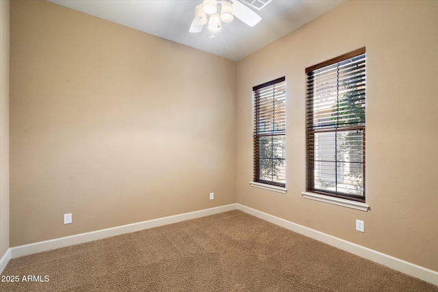 unfurnished room featuring baseboards, carpet, and a ceiling fan