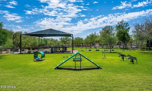 view of community with a lawn and fence