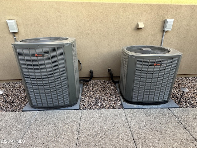 exterior details featuring central air condition unit and stucco siding