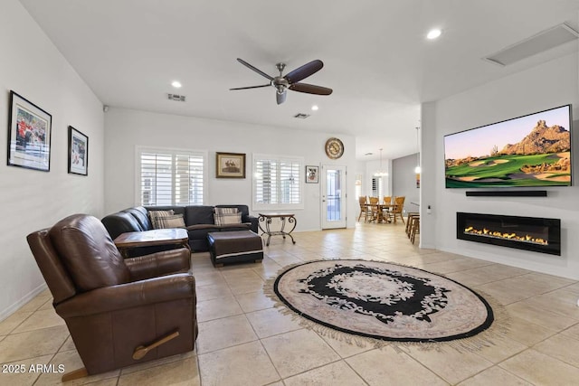 living room featuring light tile patterned flooring, ceiling fan, visible vents, and recessed lighting
