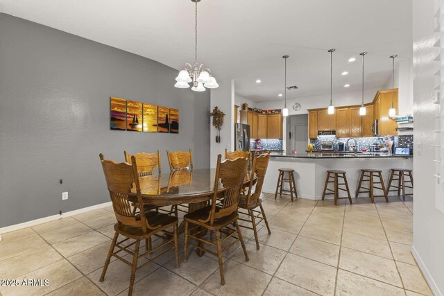 dining space with baseboards, recessed lighting, an inviting chandelier, and light tile patterned flooring