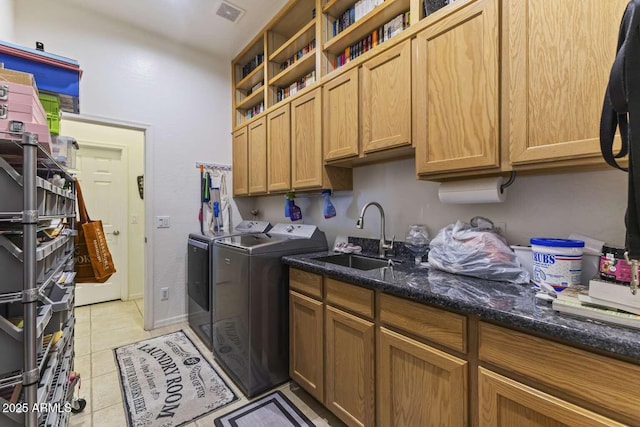 laundry room featuring visible vents, light tile patterned floors, a sink, independent washer and dryer, and cabinet space
