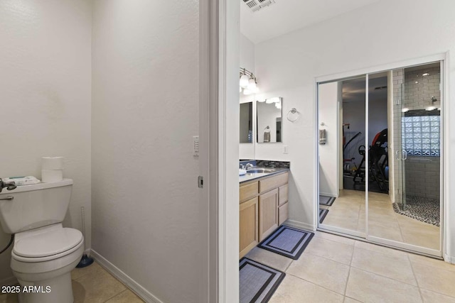 bathroom with toilet, vanity, tile patterned flooring, and visible vents