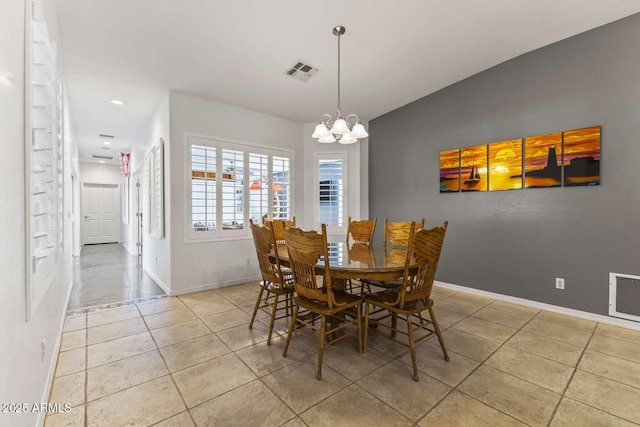 tiled dining room featuring visible vents, baseboards, an inviting chandelier, and vaulted ceiling