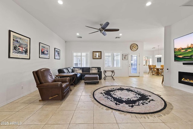 living room with light tile patterned floors, ceiling fan, recessed lighting, and baseboards