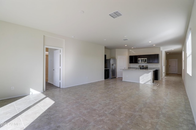 unfurnished living room with light tile patterned floors