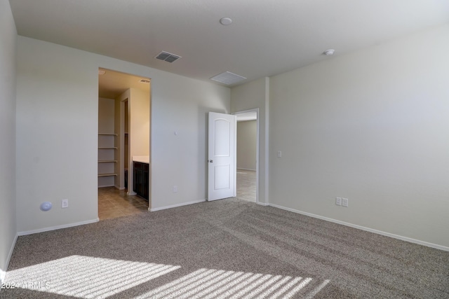 spare room featuring light carpet